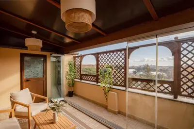 a room with two chairs and a table on a balcony at colosseo flats and penthouse in Rome