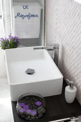 a white sink in a bathroom with purple buttons at Il Magnificus Boutique in Rome