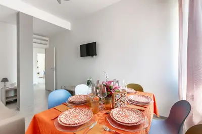 a dining room with a table with plates on it at La Casa di Anto - San Giovanni in Rome