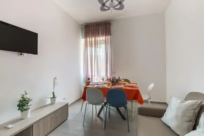 a living room with a dining room table with chairs at La Casa di Anto - San Giovanni in Rome