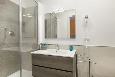 a bathroom with a sink and a shower at La Casa di Anto - San Giovanni in Rome