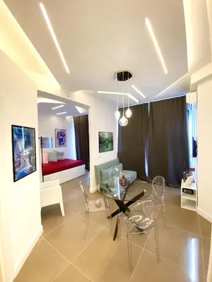 a living room with a glass table and a couch at La Maison, vicino al Colosseo! in Rome