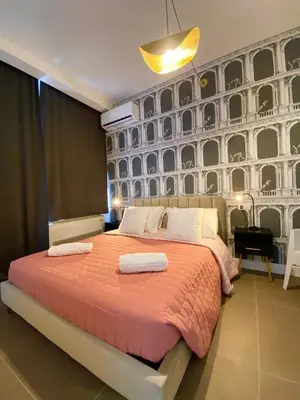 a bedroom with a large bed with a large wall at La Maison, vicino al Colosseo! in Rome