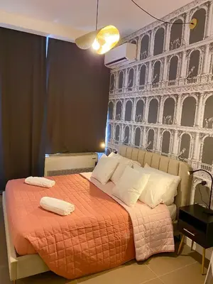 a bedroom with a bed with a wall with the coliseum at La Maison, vicino al Colosseo! in Rome