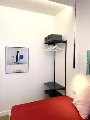 a bedroom with a red bed and a picture on the wall at La Maison, vicino al Colosseo! in Rome