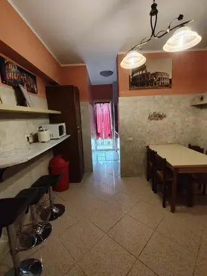 a kitchen and dining room with a table and chairs at Marco Aurelio in Rome