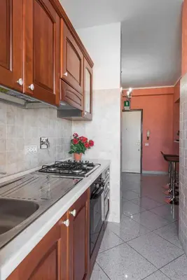 a kitchen with wooden cabinets and a stove top oven at Marco Aurelio in Rome