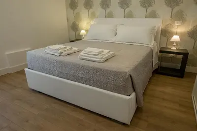 a bedroom with a bed with two towels on it at Suite Pinturicchio in Rome