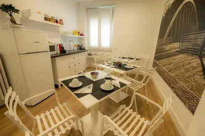 a kitchen with a table and chairs and a refrigerator at Suite Pinturicchio in Rome