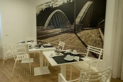 a dining room with two tables and a painting on the wall at Suite Pinturicchio in Rome