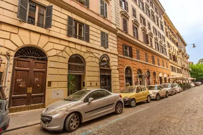 a row of cars parked next to a building at Trastevere San Cosimato vintage in Rome