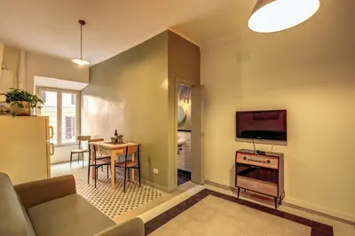a living room with a couch and a table at Trastevere San Cosimato vintage in Rome