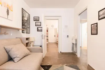 a living room with a couch and a flat screen tv at Manfredi House San Pietro in Rome