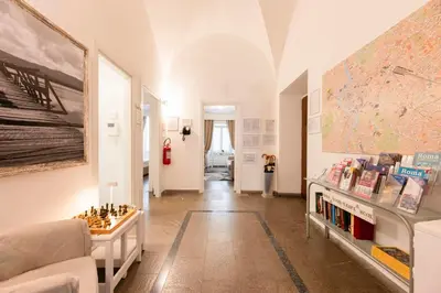 a bedroom with a white bed and a large window at Manfredi House San Pietro in Rome