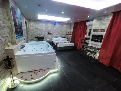 a large bathroom with a tub and a living room at Il Gladiatore in Rome