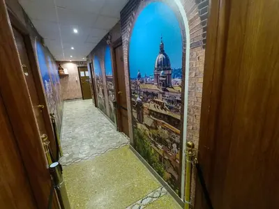 a hallway with an open door with a picture of a building at Il Gladiatore in Rome