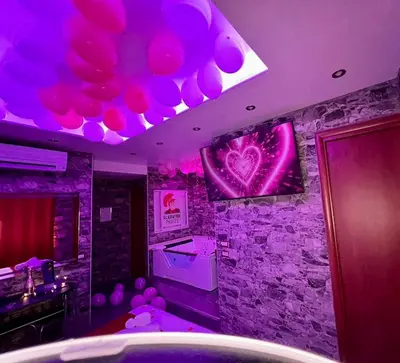 a party room with purple lights and a stone wall at Il Gladiatore in Rome