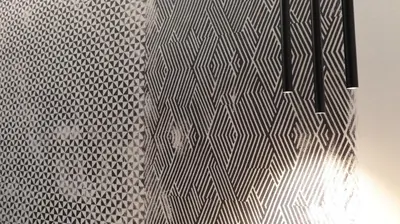a wall with a chevron pattern on it at Suite Inn Rome in Rome