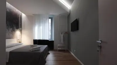 a white room with a bed and a window at Suite Inn Rome in Rome