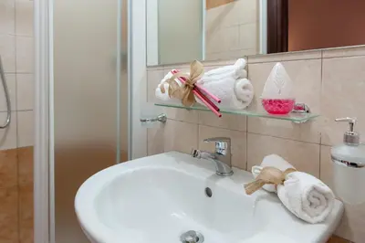 a bathroom with a sink and a mirror at ISABEL Guest House in Rome