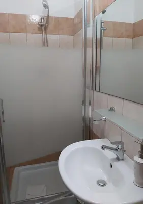 a bathroom with a sink and a mirror and a tub at ISABEL Guest House in Rome