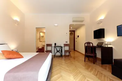 a hotel room with a bed and a desk with a computer at Residenza Delle Arti in Rome