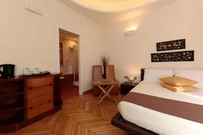 a bedroom with a bed and a dresser and a mirror at Residenza Delle Arti in Rome