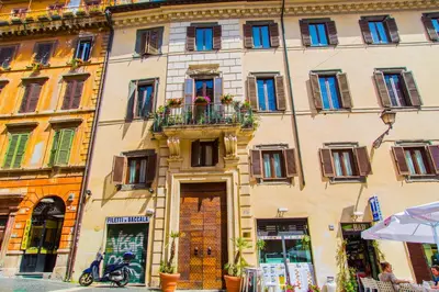 a building with a motorcycle parked in front of it at H-Aviva Giubbonari Apartment in Rome