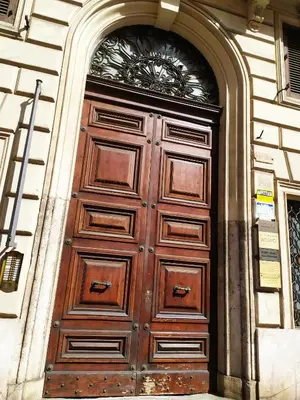 a large wooden door on the side of a building at Loft 60 - EXCLUSIVE LOFT ROME CITY CENTER in Rome