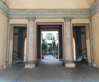 an entrance to a building with columns and plants at Loft 60 - EXCLUSIVE LOFT ROME CITY CENTER in Rome