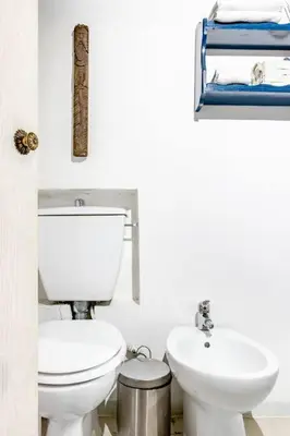 a bathroom with a toilet and a sink at Trastevere Alley Apartment in Rome