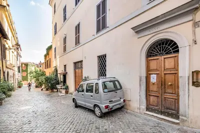 a small car parked in front of a building at Trastevere Alley Apartment in Rome