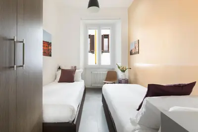 a bedroom with two beds and a window at ROMAC Villa Borghese with 3 bedrooms near Via Veneto in Rome