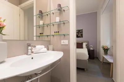a bathroom with a sink and a mirror at ROMAC Villa Borghese with 3 bedrooms near Via Veneto in Rome