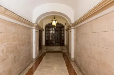 an empty hallway with a door and a lamp at ROMAC Villa Borghese with 3 bedrooms near Via Veneto in Rome