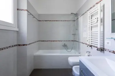 a bathroom with a tub and a toilet and a sink at ROMAC Mazzini with 5 bedrooms near the Vatican in Rome