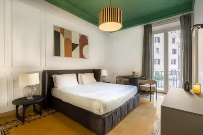 a bedroom with a bed and a large window at ROMAC Mazzini with 5 bedrooms near the Vatican in Rome