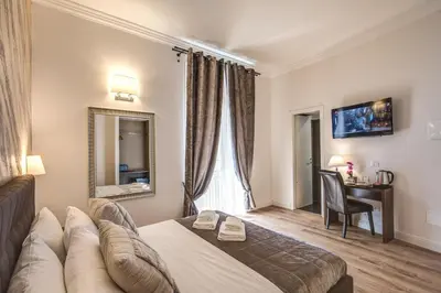 a hotel room with a bed and a couch at River Luxury Suites in Rome
