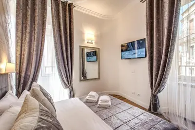 a bedroom with a bed and a window at River Luxury Suites in Rome