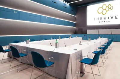 a conference room with a long table and chairs at The Hive Hotel in Rome