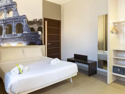 a bedroom with a white bed and a tower at B&B Hotel Roma Trastevere in Rome
