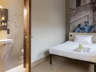 a bedroom with a bed and a statue of a man at B&B Hotel Roma Trastevere in Rome