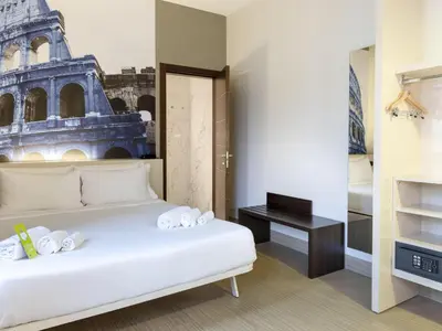 a hotel room with a bed and a mirror at B&B Hotel Roma Trastevere in Rome
