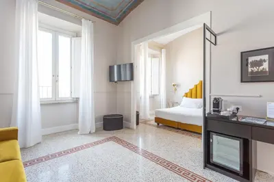 a white room with a bed and a mirror at Daplace - La Mongolfiera Rooms in Navona in Rome