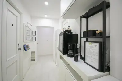 a room with a counter with a television and a window at Caffe' e Cuscino in Rome