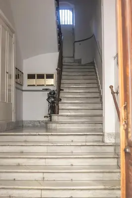 an empty staircase in an old building with a window at Caffe' e Cuscino in Rome