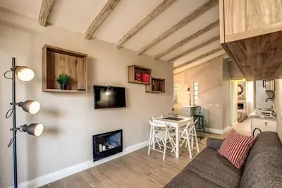 a living room with a couch and a table at Attic with Terrace by Trevi Fountain in Rome