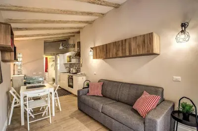 a living room with a couch and a table at Attic with Terrace by Trevi Fountain in Rome