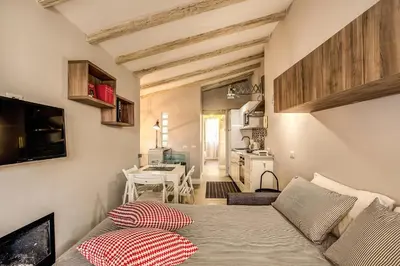 a living room with a couch and a table at Attic with Terrace by Trevi Fountain in Rome
