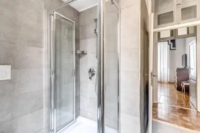 a shower with a glass door in a bathroom at Lovely renovated flat by Vatican in Rome